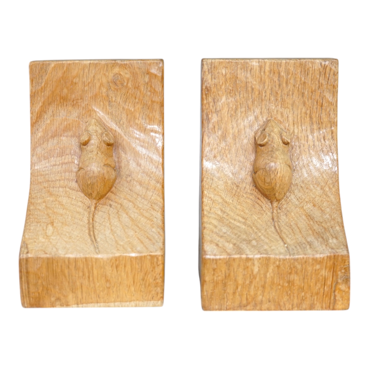 Workshop of Robert ‘’Mouseman’’ Thompson of Kilburn - a pair of English oak single mouse bookends, each with carved mouse trademark, 15cm high. Condition - good.